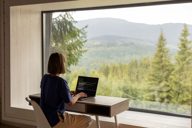 Image of woman working at desk by window