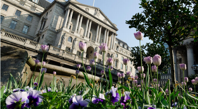 Spring tulips bloom in front of the imposing facade of the Bank of England on Threadneedle Street in the City of London.
