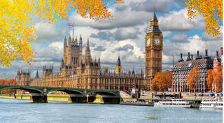 Big Ben tower with Houses of Parliament and Westminster bridge in autumn, London, UK