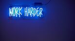 Neon sign saying work harder