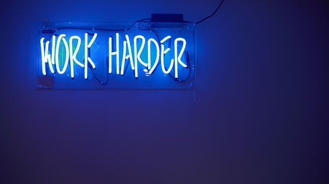 Neon sign saying work harder