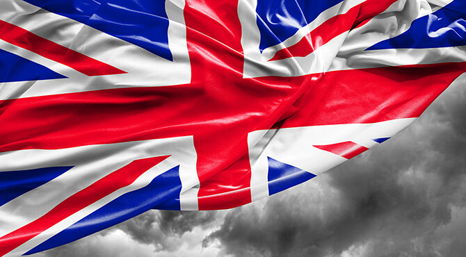 British flag over dark cloud illustrates an article about the UK economy and Brexit