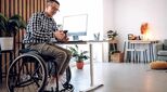 Image of man in wheelchair working at desk