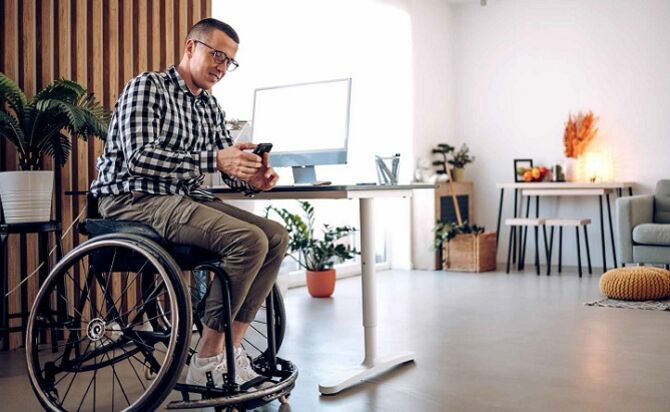 Image of man in wheelchair working at desk