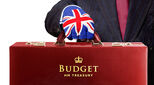 Man holding a budget box (UK) while wearing Union Jack glove