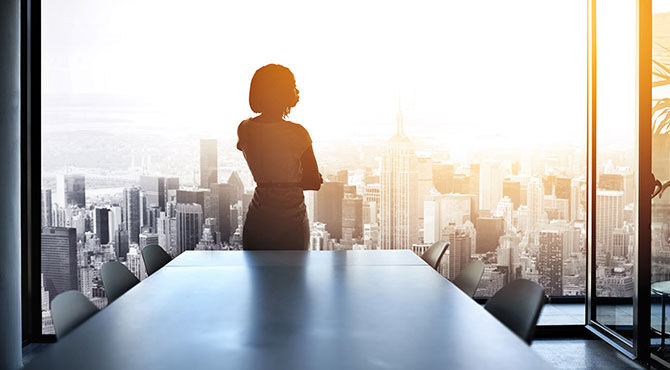 Woman in office overlooking city