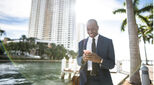 Businessperson looking happily at handheld device