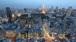 Dusk in Paris with office buildings and the Eiffel Tower illuminated