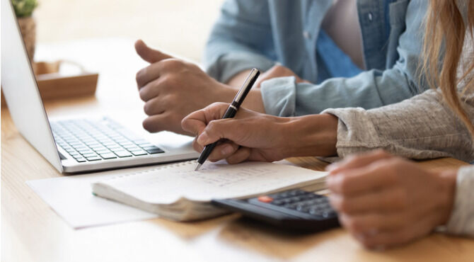 Close up of couple working our household finances