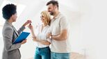 Image of happy couple collecting house keys from estate agent