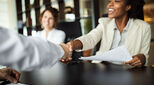 Woman shaking a hand to symbolise a deal sealed