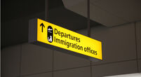 the sign directing people to departures and immigration's offices