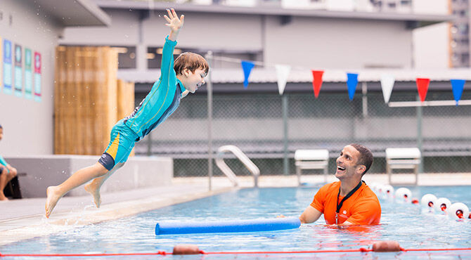 Dover Court International School child and instructor in swimming pool