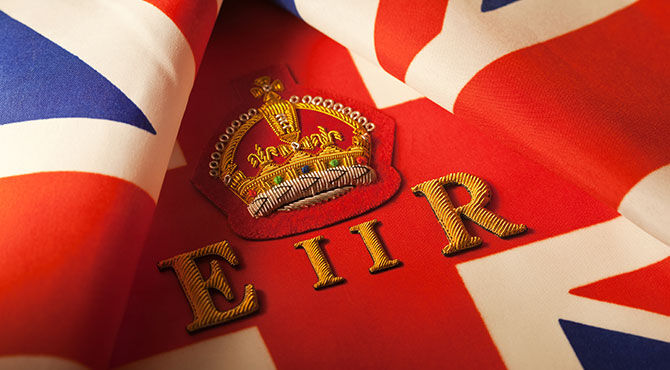 Union Jack flag with insignia of the crown of Queen Elizabeth II to illustrate an article about the Queen\\\'s latest UK awards
