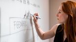 Person writing on board