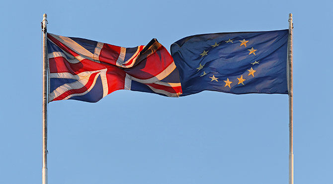 EU and UK flags flying towards each other