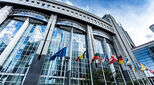 European parliament building and flying flags