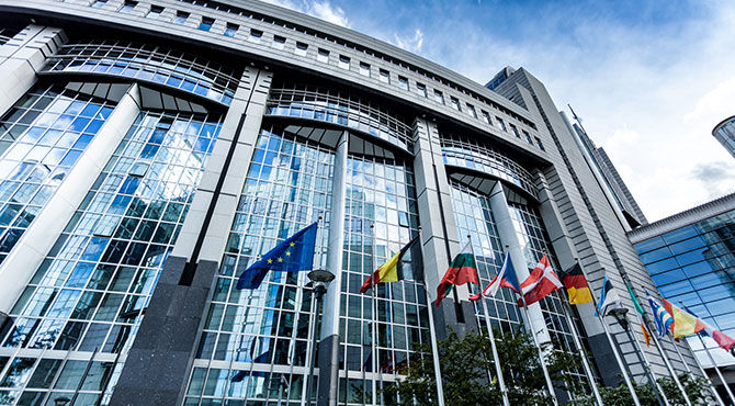 European parliament building and flying flags