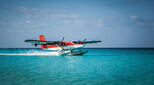 Image of a seaplane on water in a remote location