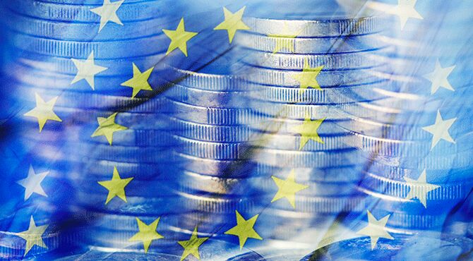 Bank coins against background of EU flag