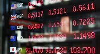 Board showing different currencies for an article about foreign exchange FX