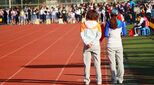 Image of college athletics track and competitors