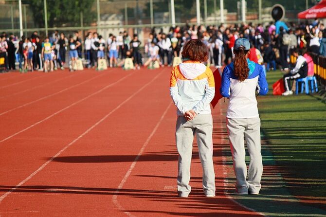 Image of college athletics track and competitors