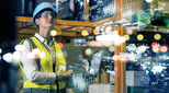 Female engineer in hard hat looks upwards