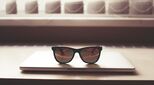 Image of closed laptop with dark shades