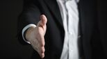 Image of outstretched hand offering handshake to seal a deal