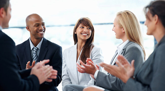 Office workers talking and looking happy