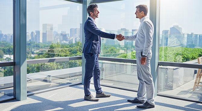 Two men shaking hands illustrates an article about repats and talent management