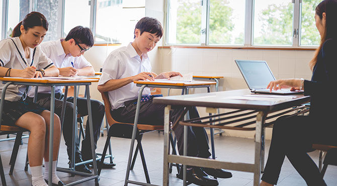 Teacher Surveying Physics Exam, Hong Kong School