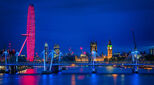 Image of the London skyline at night, featuring the Houses of Parliament and London Eye