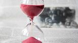 Image of an hour-glass and newspaper