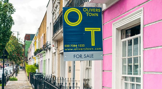 House for sale sign on a street