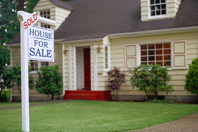 Image of house and for sale board