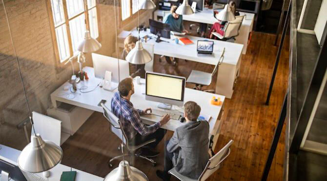 Small businesses need £13m a year to boost productivity: CIPD - image of people in an open plan office