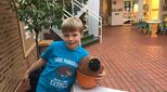 Lukas standing with Pangolin