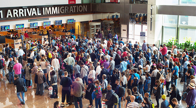 Passengers wait at immigration