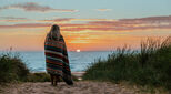 Woman in blanket on a beach