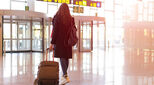 Young woman at an airport with suitcase