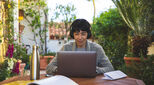 Image of happy remote worker on sunny patio