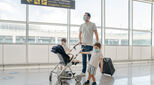 Image of family in face masks struggling at airport