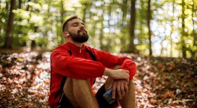 Image of man sitting in forest