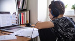 School child studying hard at home on laptop