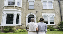 couple looking at house picture