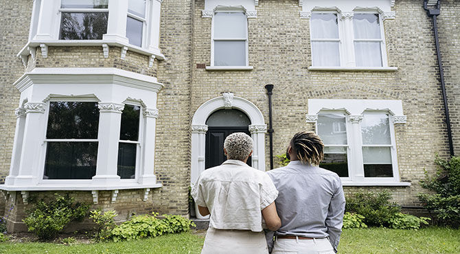 couple looking at house picture