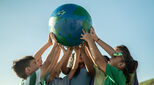 Children holding up planet