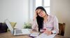 Image of young women at desk with credit card and calculator